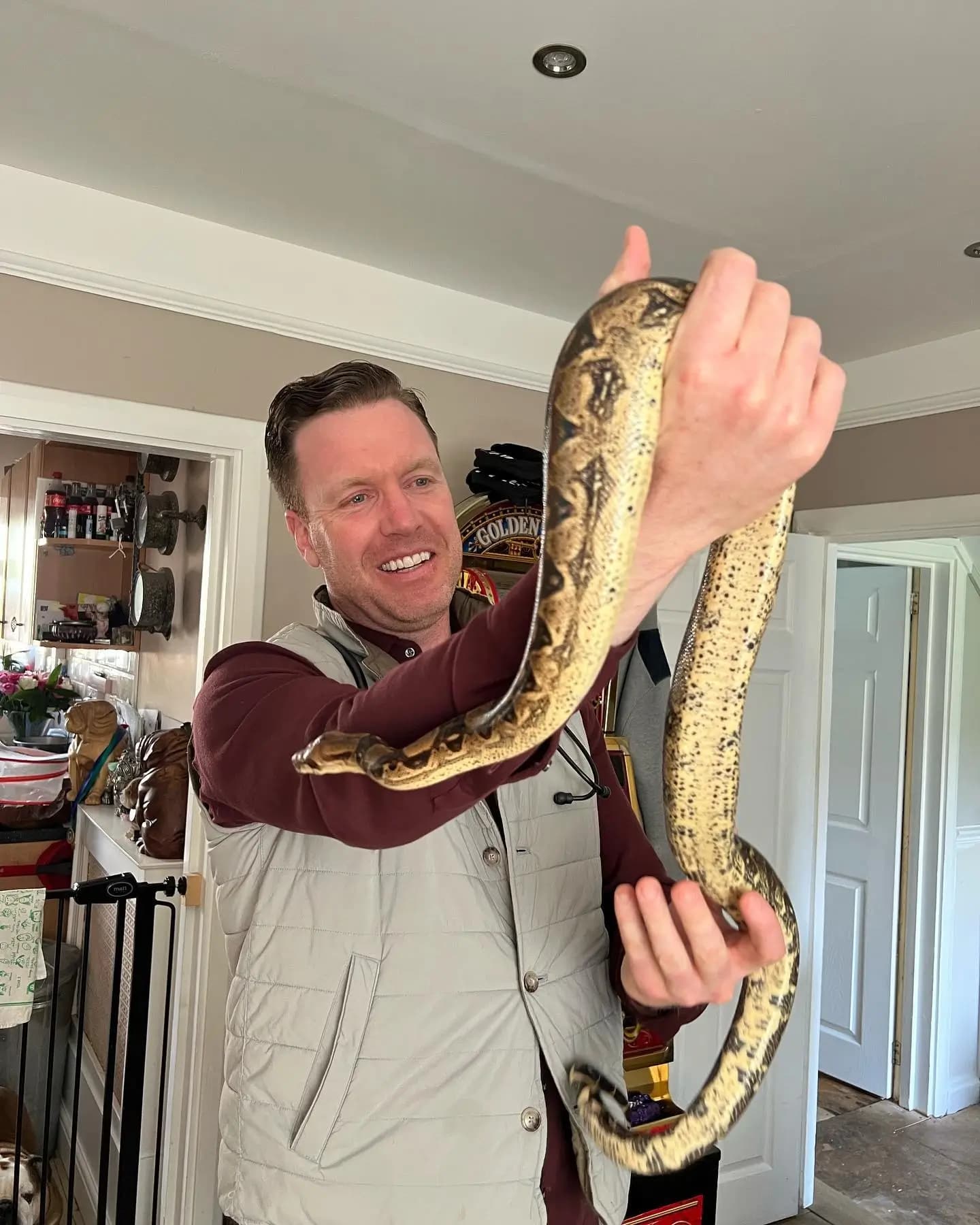 Dr. Tony with a snake in London during a home vet visit