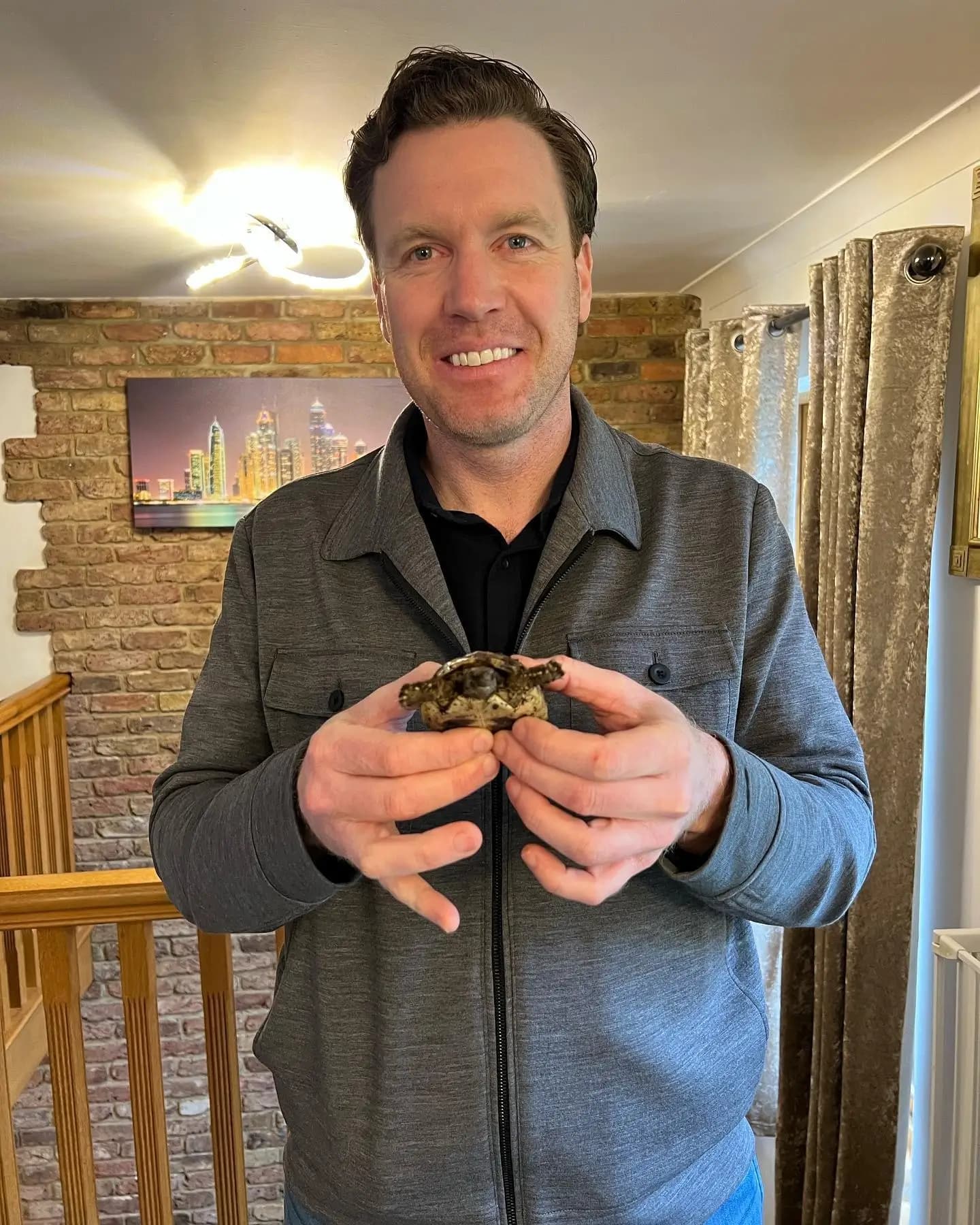 Dr. Tony with a turtle in London during a home vet visit