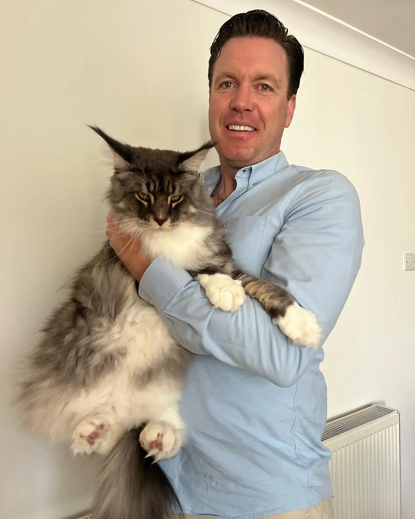 Dr. Tony with a cat in London during a home vet visit