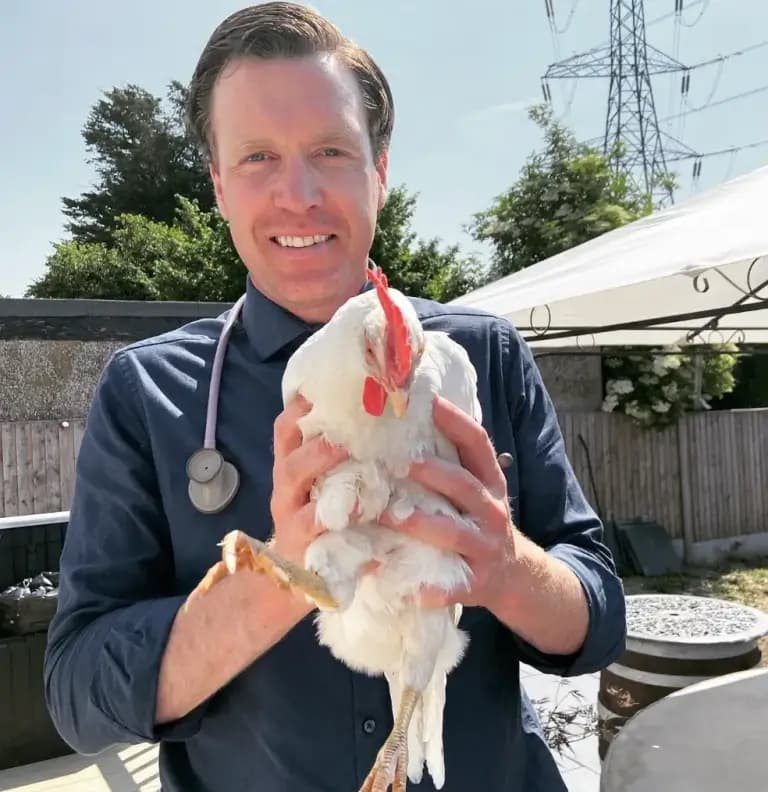 Dr. Tony with a chicken in London during a home vet visit